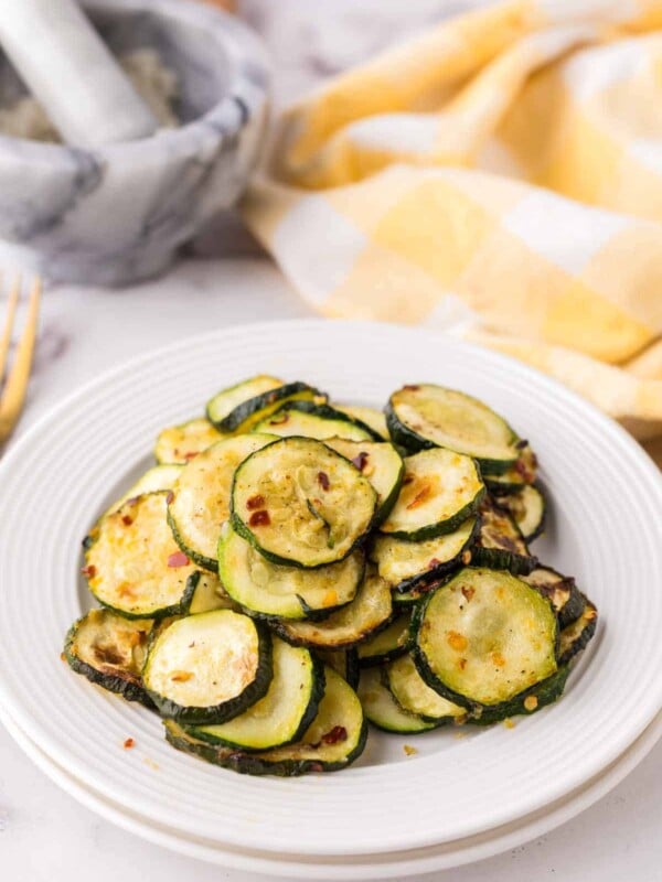 air fryer zucchini on a white plate.