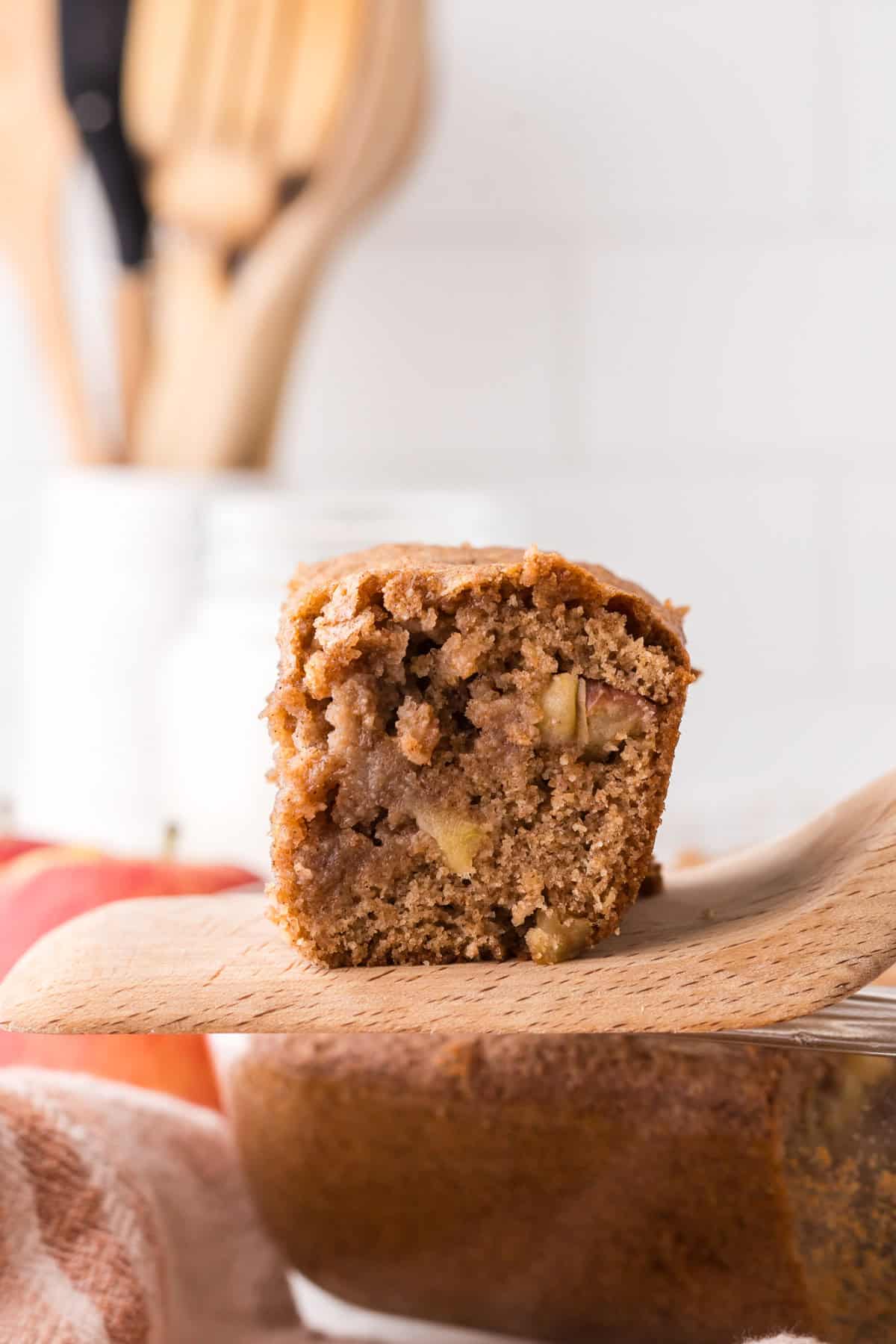 apple cake square slice on a wooden spatula.