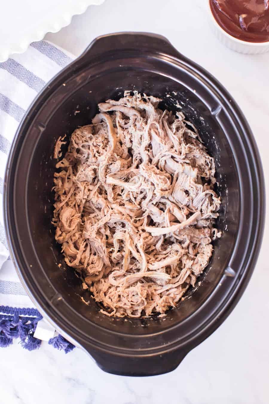 crock pot of pulled pork, cooked and shredded.