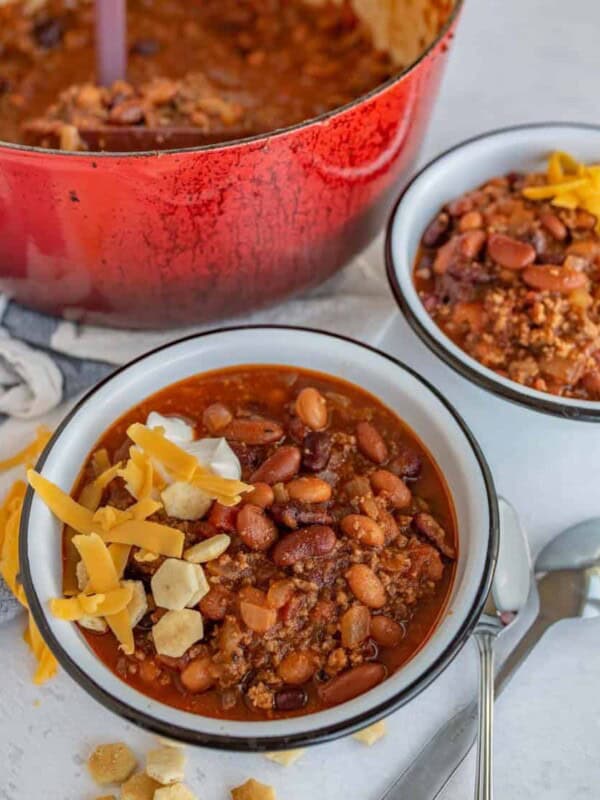 two bowls of chili in white bowls