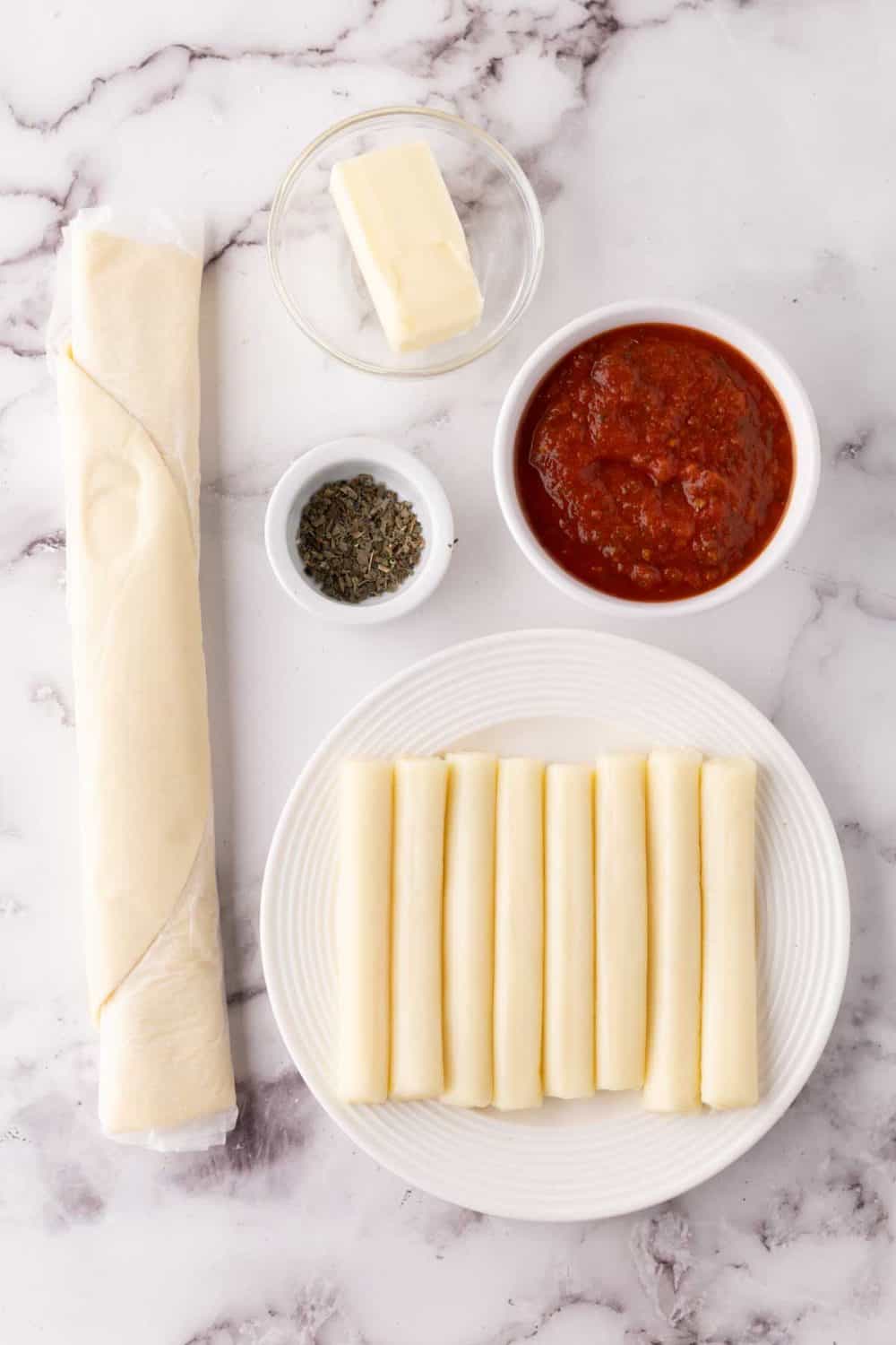 portion bowls each with raw ingredient to make bosco sticks.