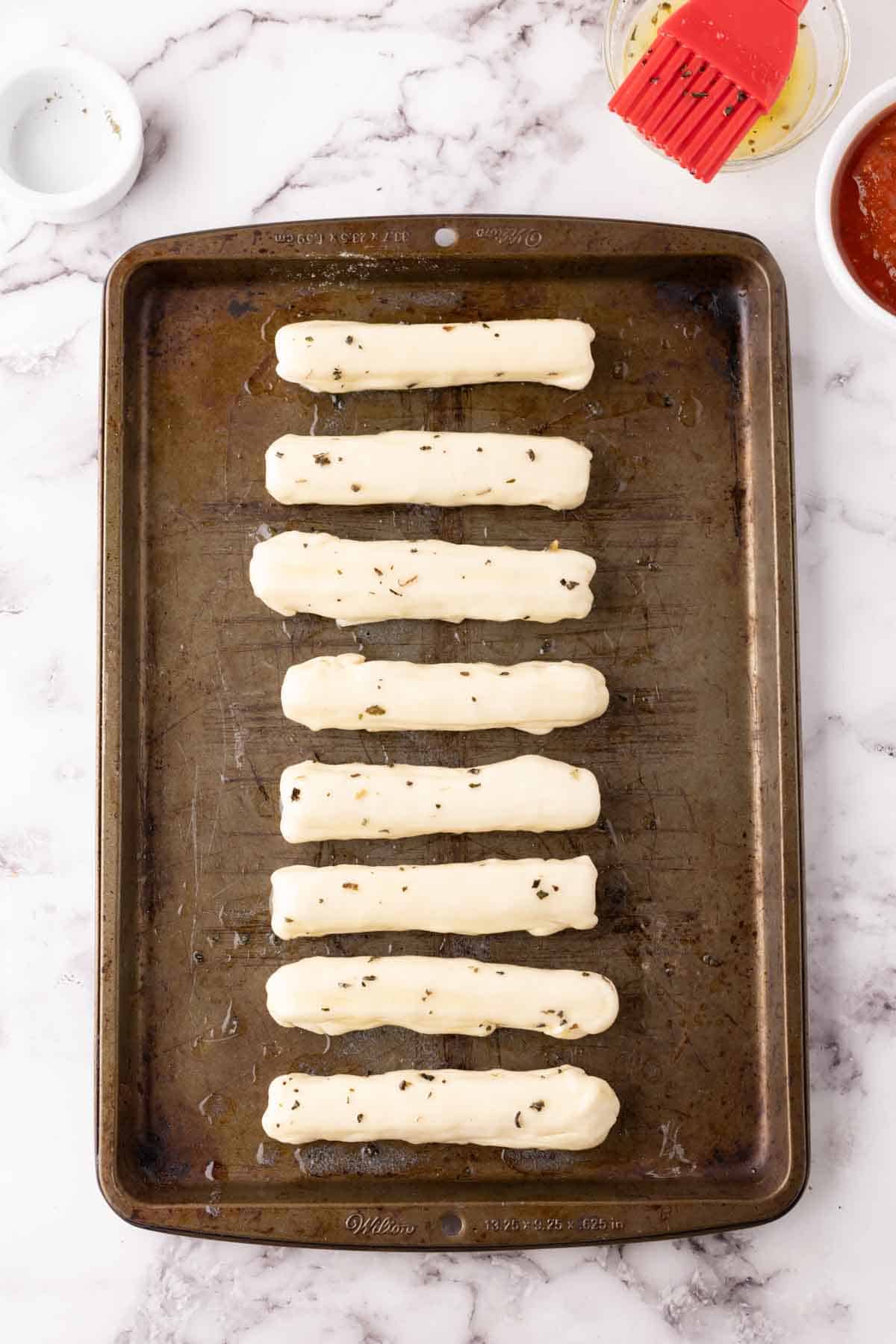 raw bosco sticks recipe in progress on a sheet pan.