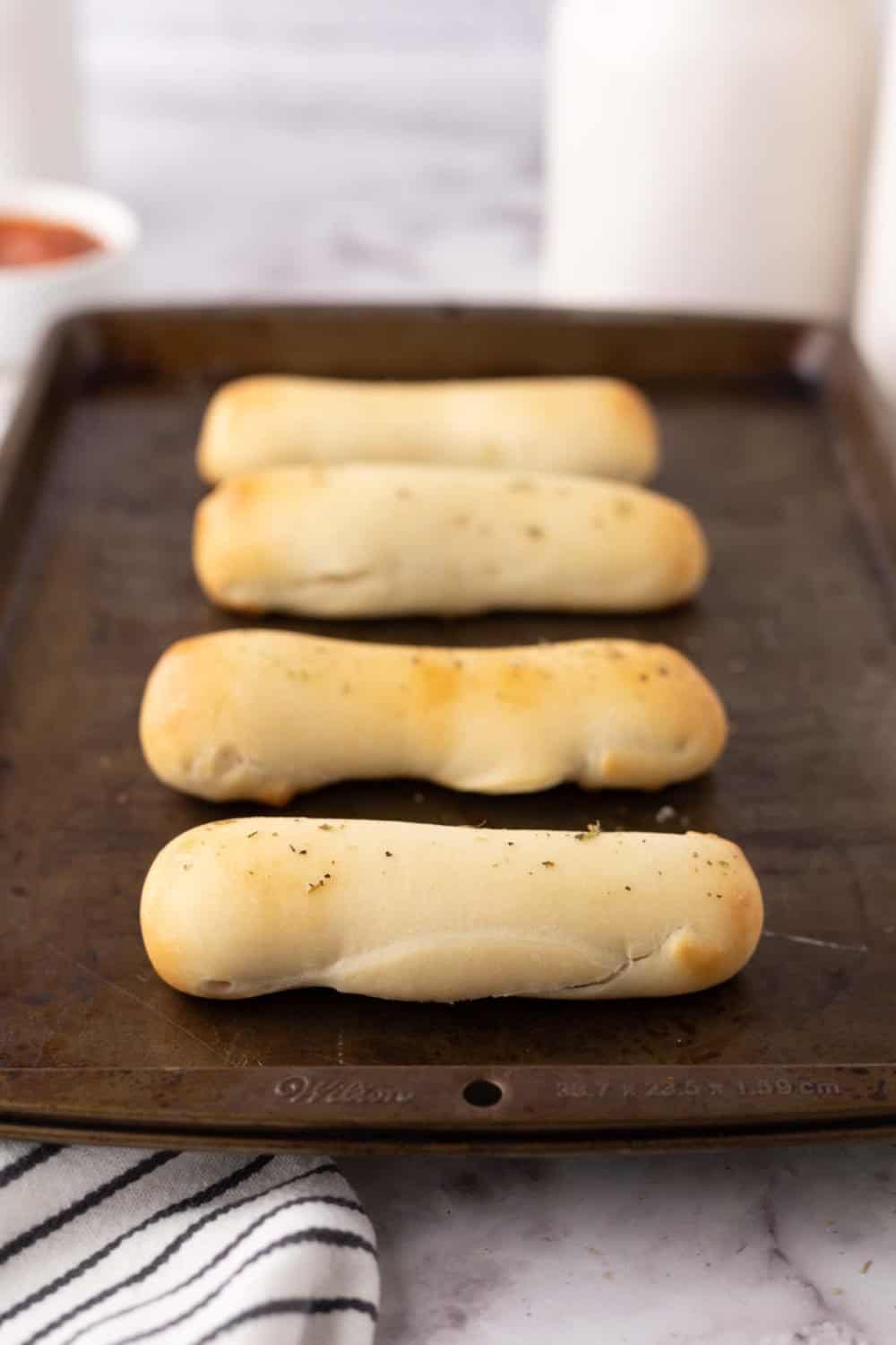 four bosco sticks on a cookie sheet.