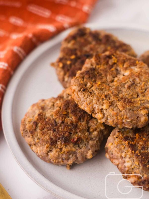 round plate with a stack of homemade breakfast sausage.