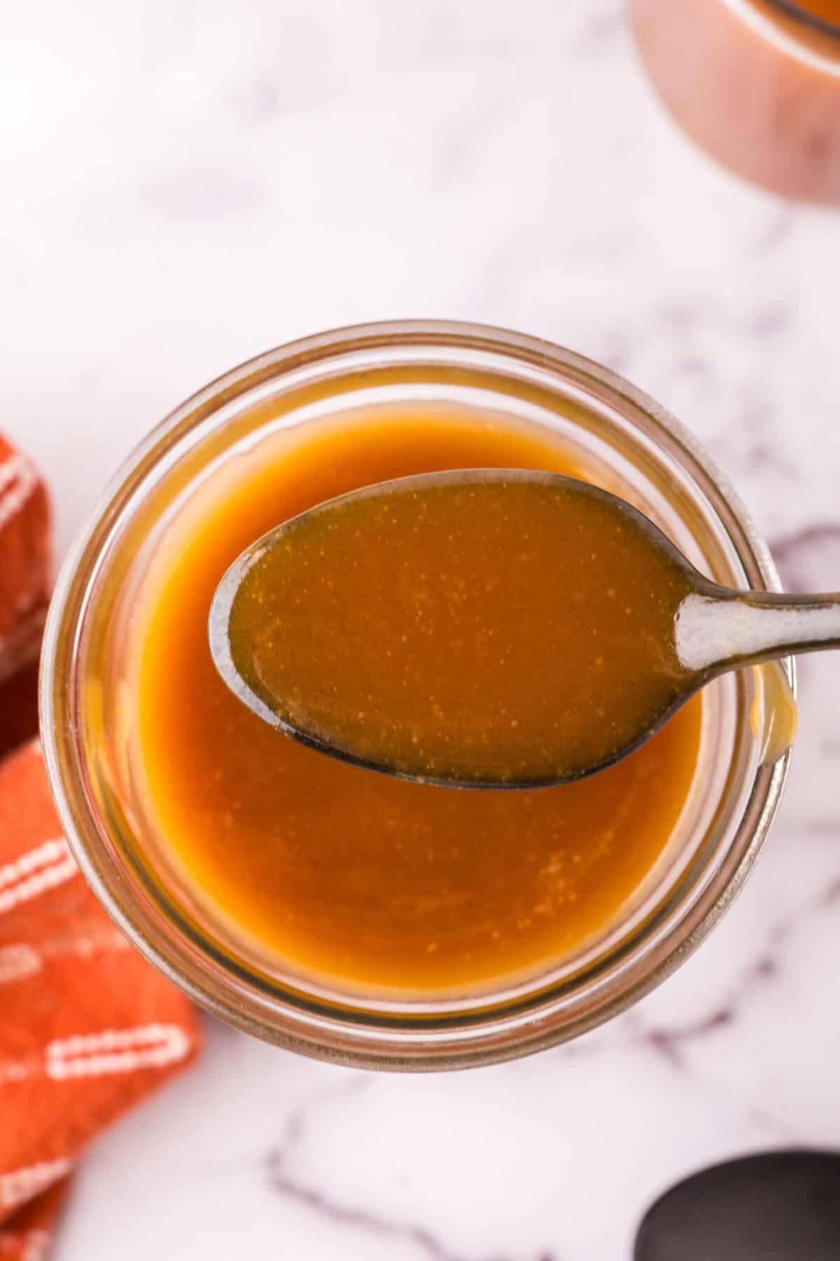 glass jar filled with homemade caramel sauce.