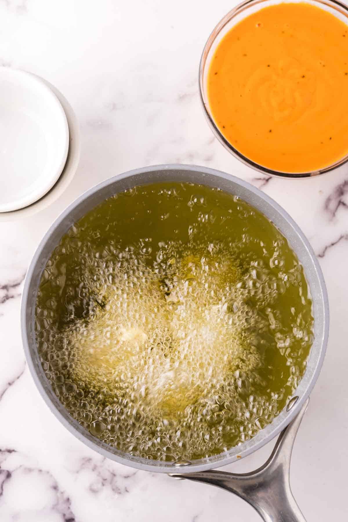 pot of hot oil to deep fry cauliflower wings.