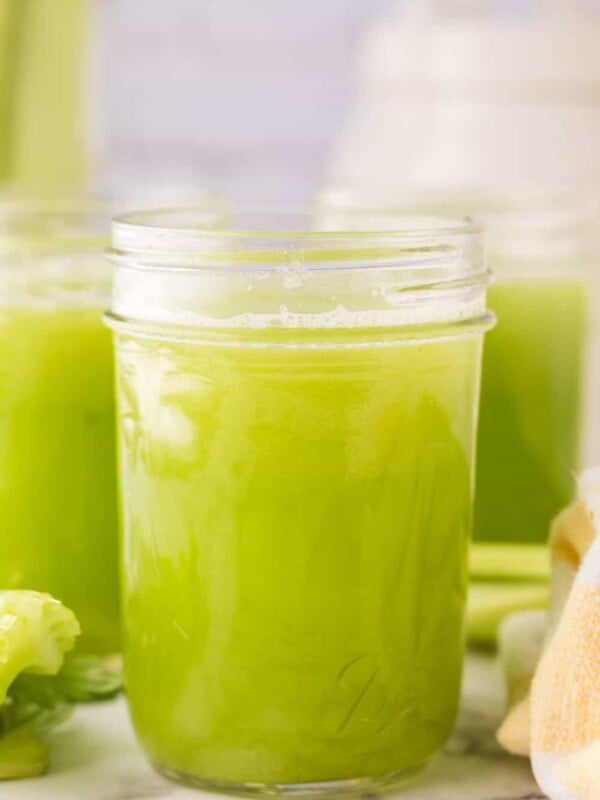 small mason jars with green celery juice.