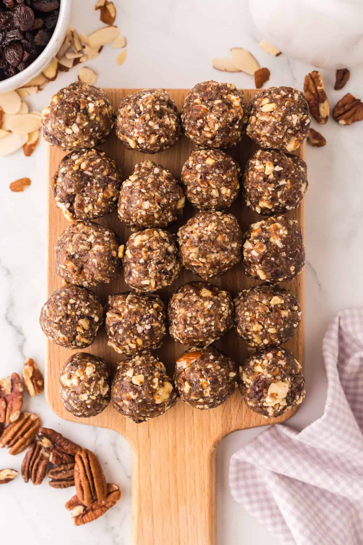 cherry energy balls on a wooden board.