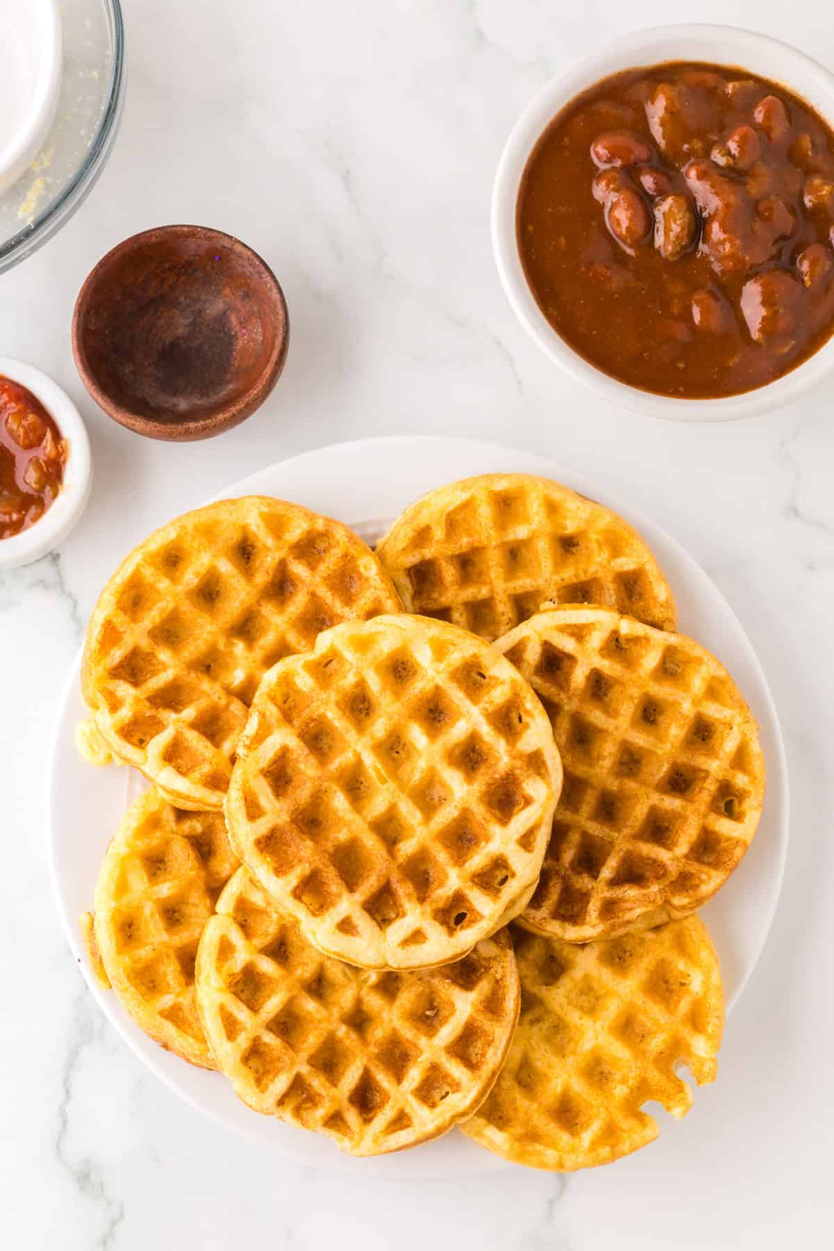 pile of cornbread waffles with chili.