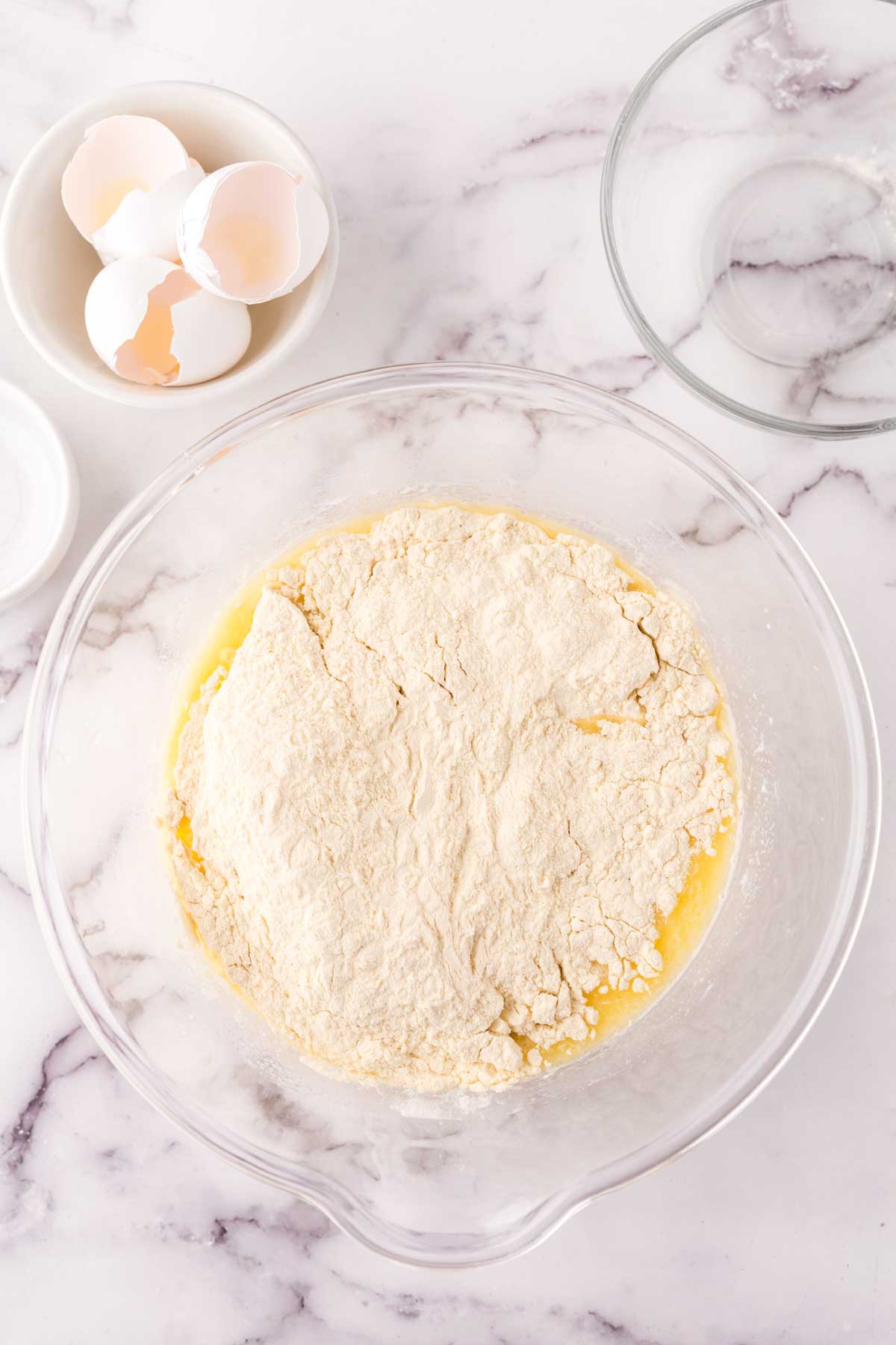 clear mixing bowl in the process of making crepe batter.