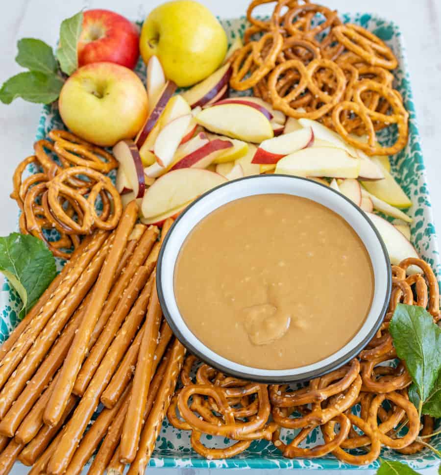 apples and pretzels laid around a bowl of homemade caramel dip.