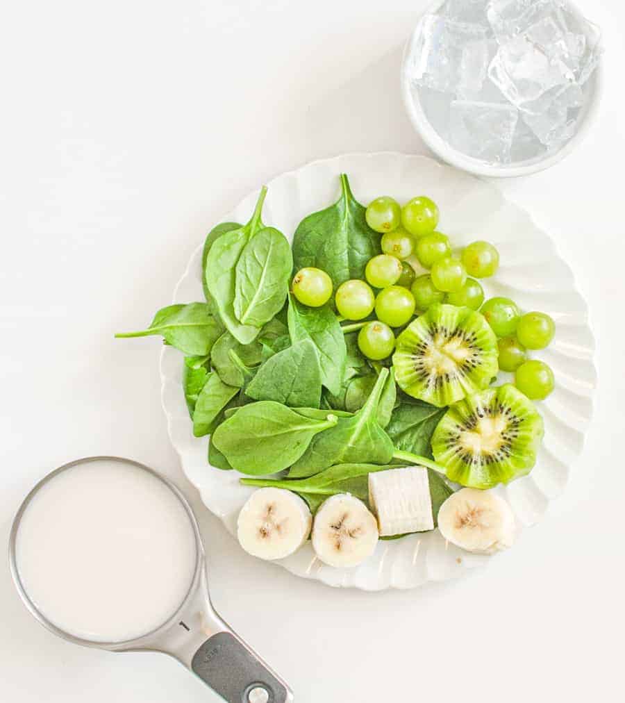 spinach with kiwi and bananas and green grapes ready for smoothie.