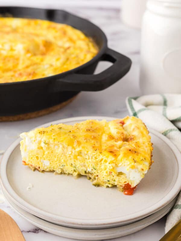 Farmhouse egg bake recipe in triangle pie slices on round plate.