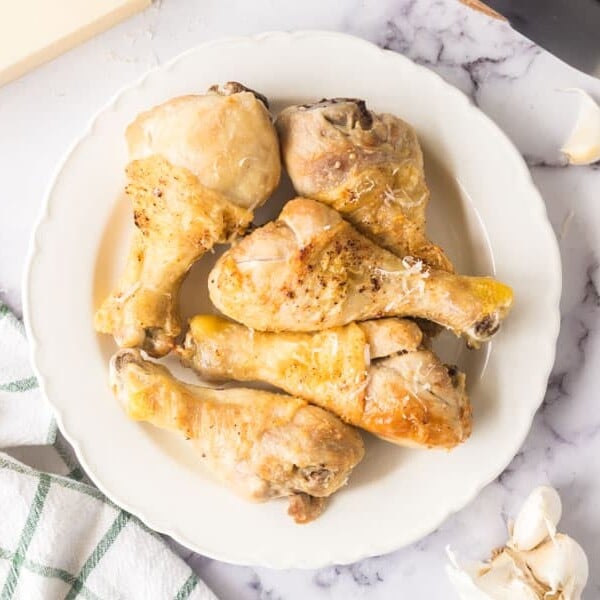 garlic parmesan air fryer chicken wings stacked on a plate