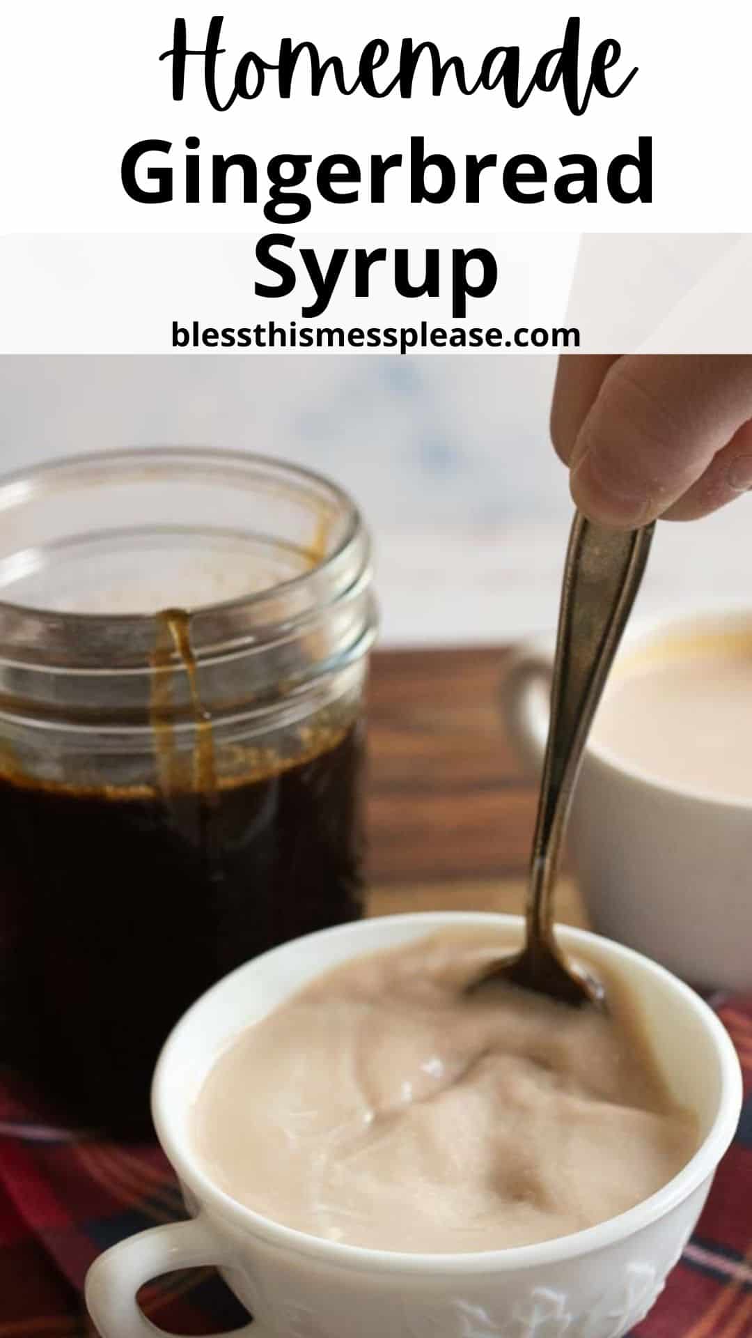 A spoon stirring creamy mixture in a white cup, next to a jar of dark gingerbread syrup. The text above reads Homemade Gingerbread Syrup and the website blessthismessplease.com.