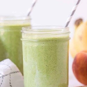 side view of green smoothie in mason jar.