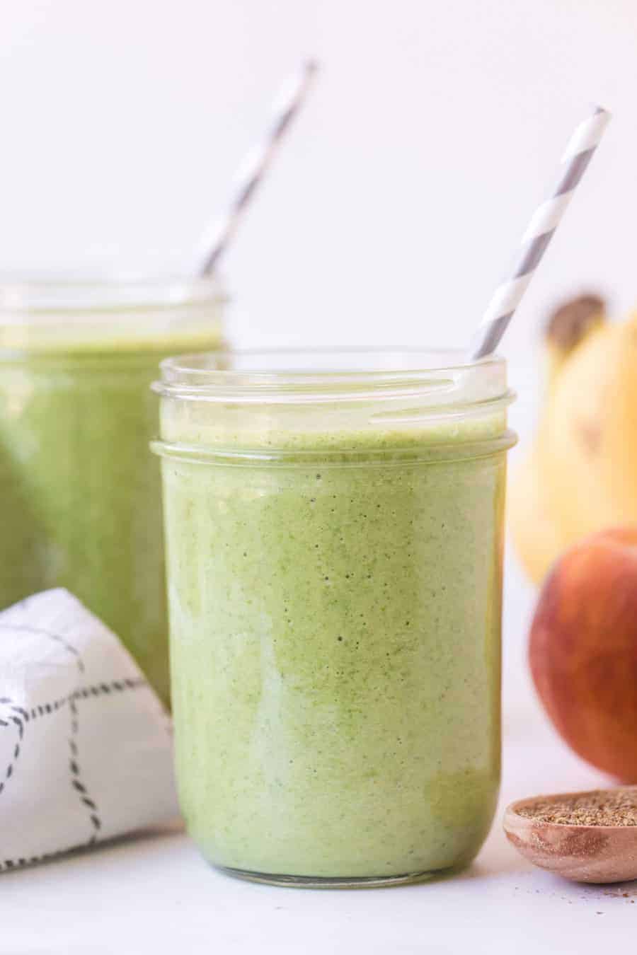 side view of green smoothie in mason jar.