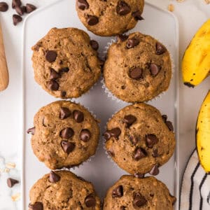 healthy banana muffins on a white cutting board.