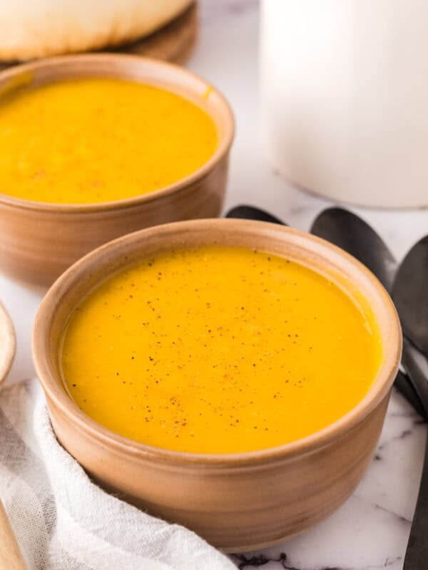 homemade butternut squash soup in two serving bowls.