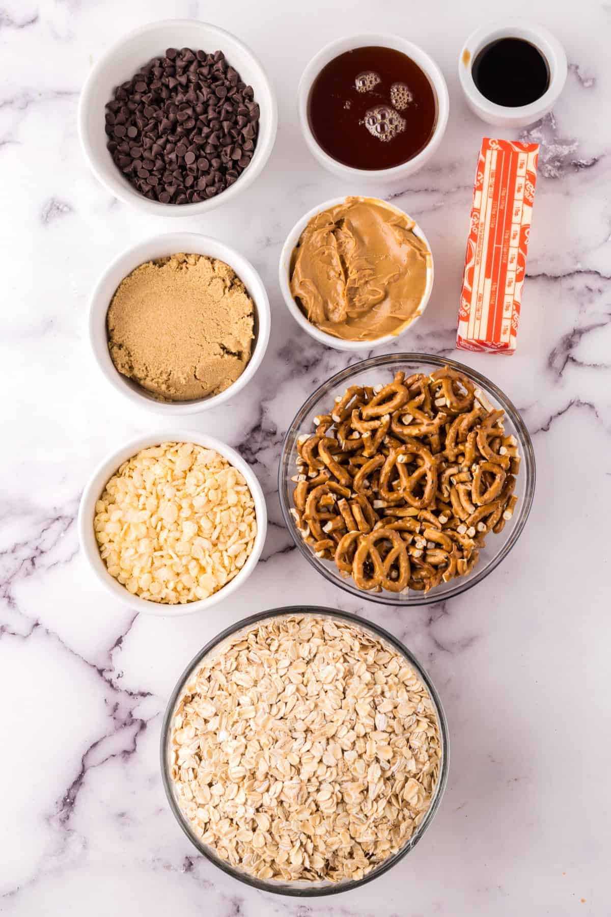 portion bowls each with raw ingredients to make homemade granola bars.