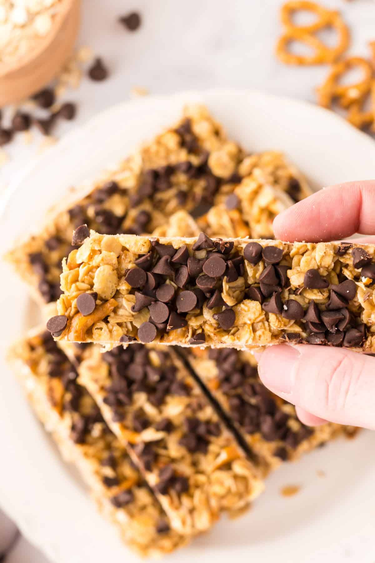 POV hand holding a Homemade granola bar with chocolate chips.