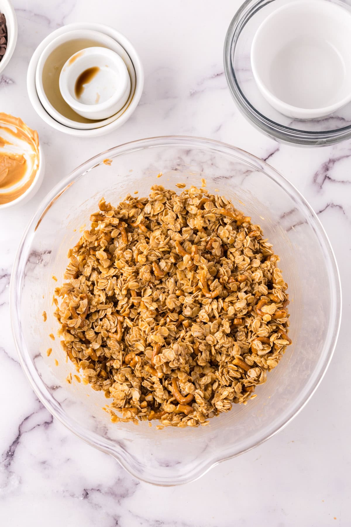 clear mixing bowl the progress of making the homemade granola bar recipe.