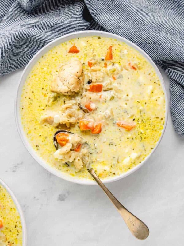 top view of creamy soup with chicken and rice popping out.