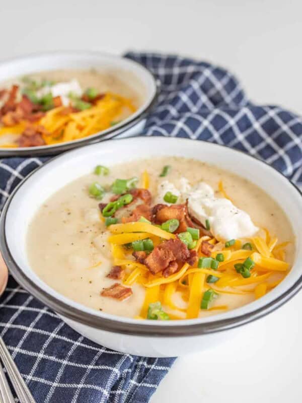 All the heartiness of a baked potato comes together in this rich and fast-as-can-be Instant Pot Loaded Baked Potato Soup, topped with shredded cheddar, crispy bacon bits, green onion, and sour cream.