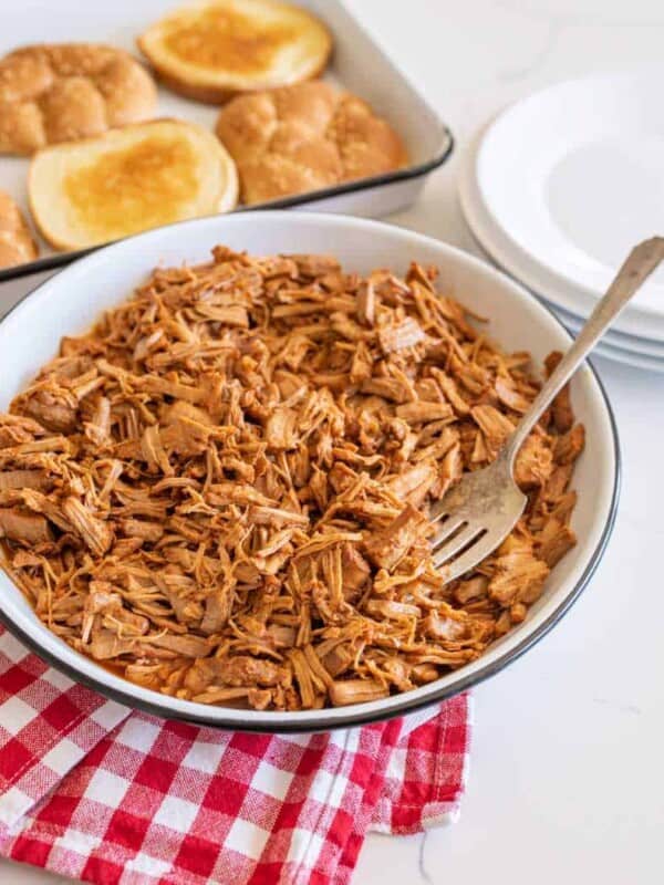 pulled barbecue pork on serving platter with fork.