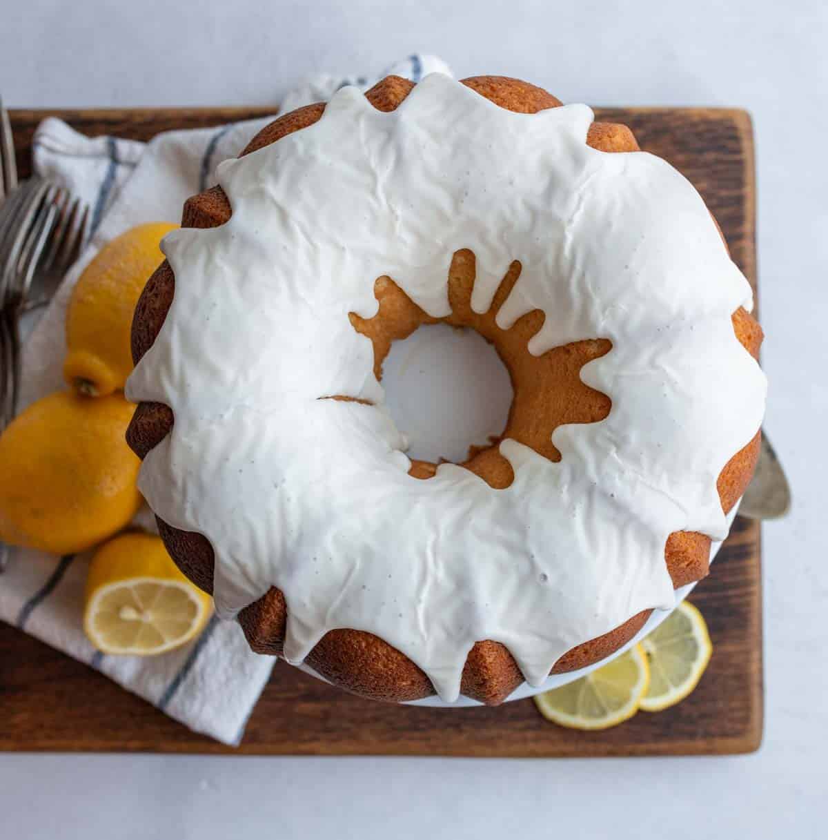 whole round lemon bundt cake with white icing.