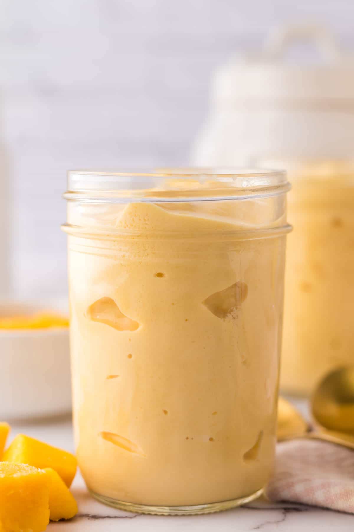 Mango lassi in glass mason jars.