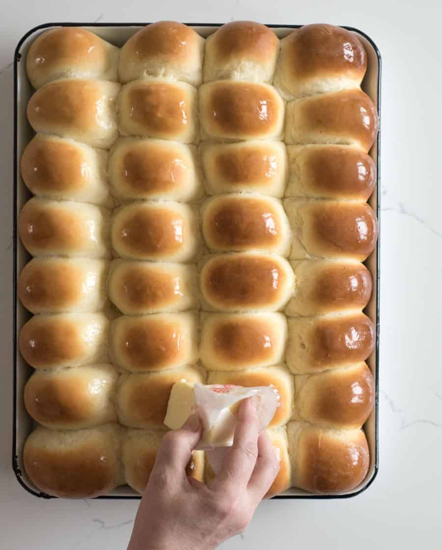 light and fluffy dinner rolls fresh out of the oven and having butter rubbed on the tops.