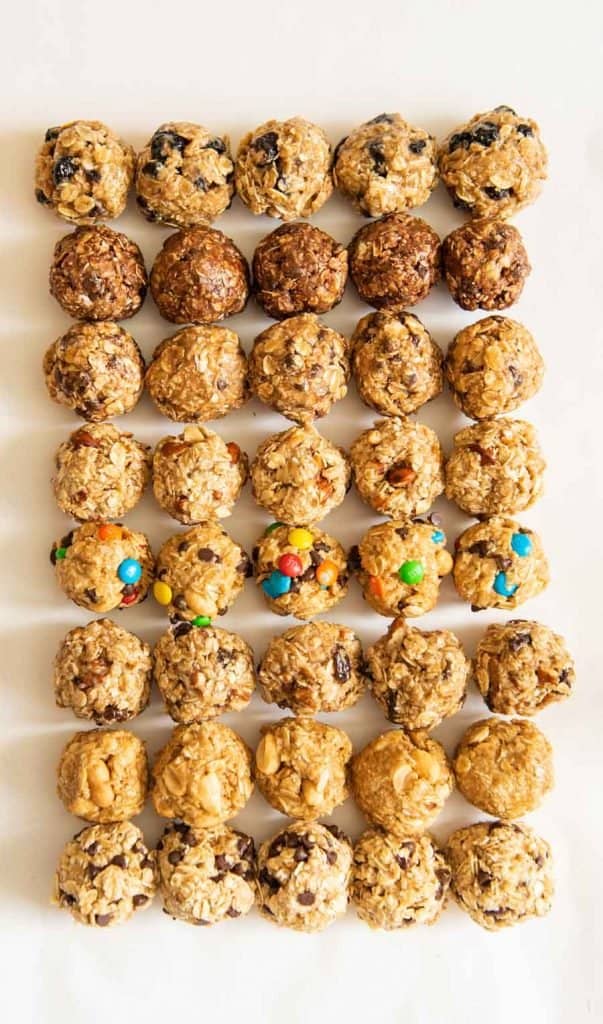 all 8 kinds of oatmeal energy bites all lined up in a 5 by 8 pattern on a white board