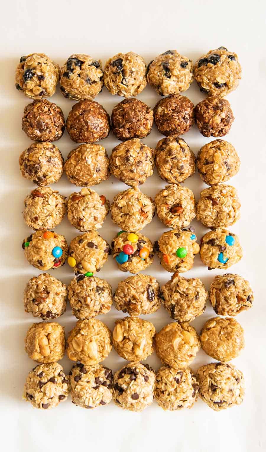 Five of each of the eight no-bake oatmeal energy balls on a white counter. 