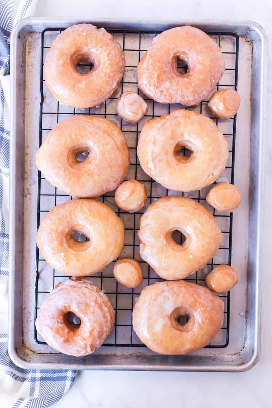 Rack of glazed donuts and doughnut holes.