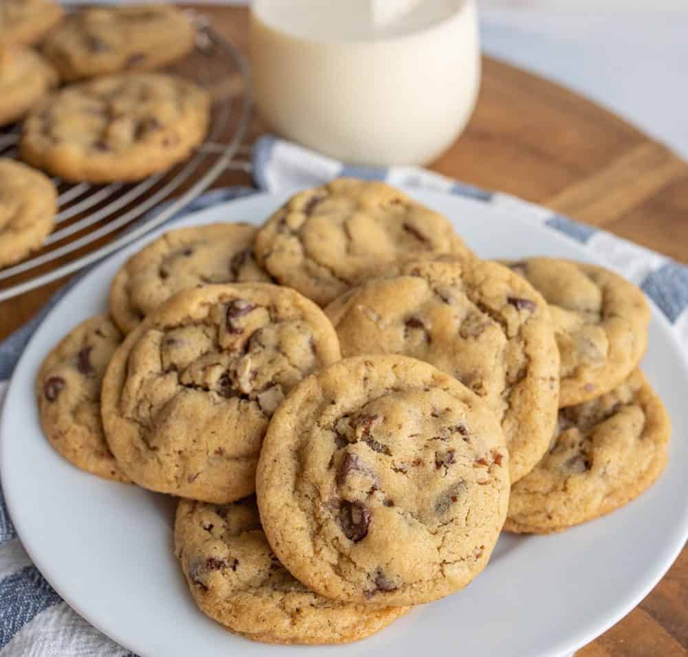 a plate stacked with chocolate chip cookies.