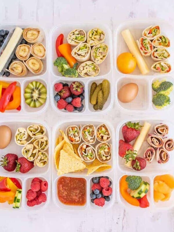 lots of different tupperware with lunch items separated in compartments.