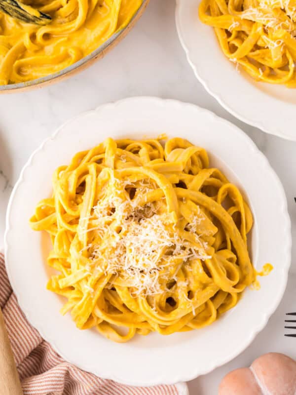 pumpkin Alfredo recipe on a white plate.