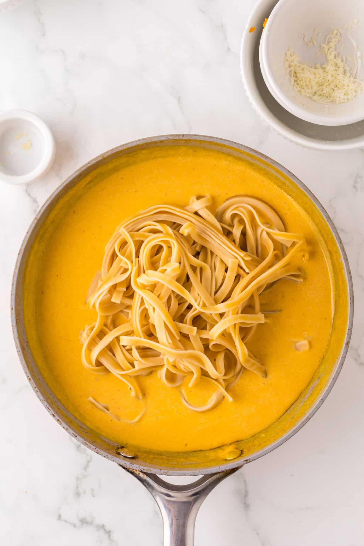 pumpkin Alfredo recipe in progress in a big pot.