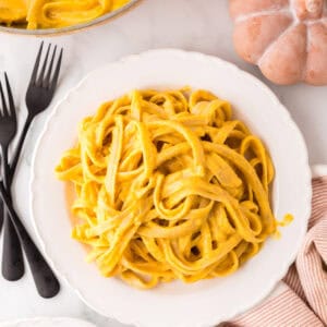 pumpkin Alfredo recipe on a round white plate.