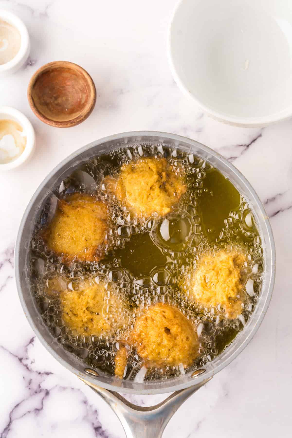 hot oil deep fryer in the process of making pumpkin donut holes.