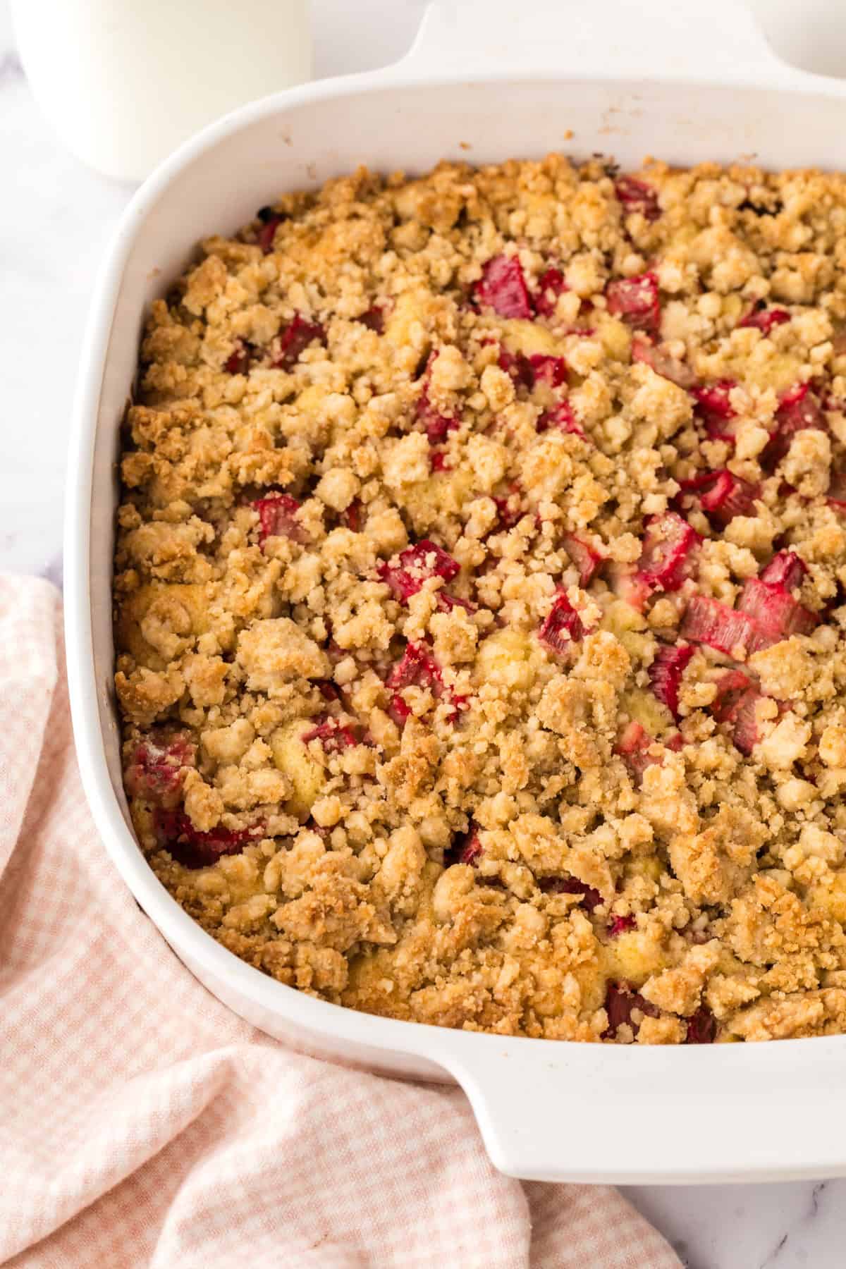 glass dish with baked rhubarb crumb bar recipe inside.