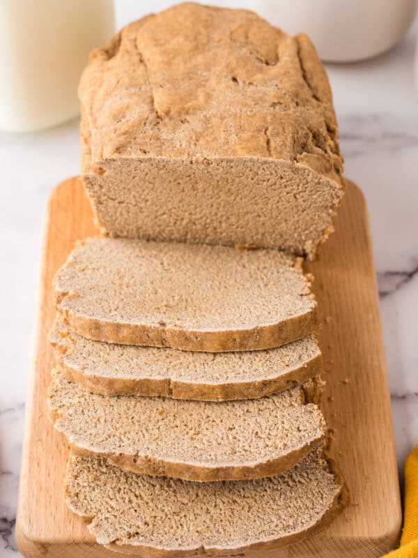 whole loaf with about half sliced and laid out of a fresh baked sandwich bread recipe.