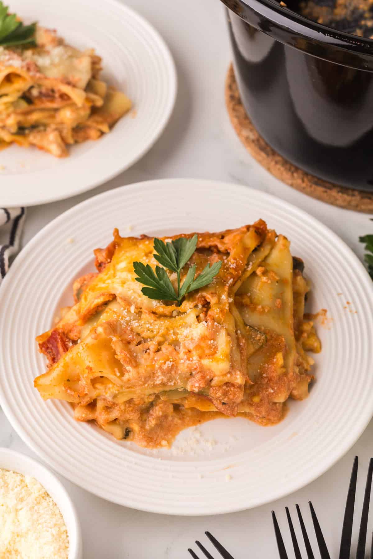 slow cooker veggie lasagna recipe served on a round white plate.