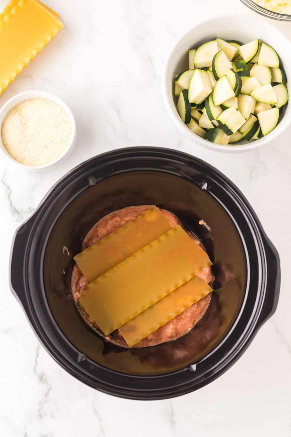 crock pot with ingredients to make slow cooker veggie lasagna sauce.