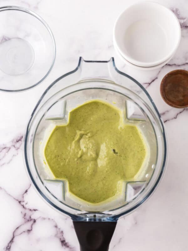 green smoothie inside the blender pitcher.