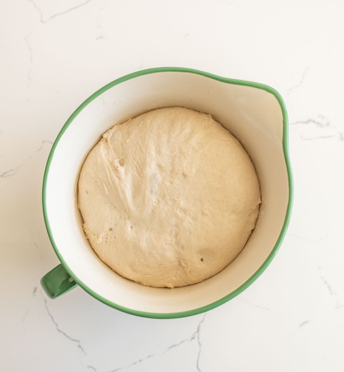 ball of dough in green bowl for sourdough no knead bread.