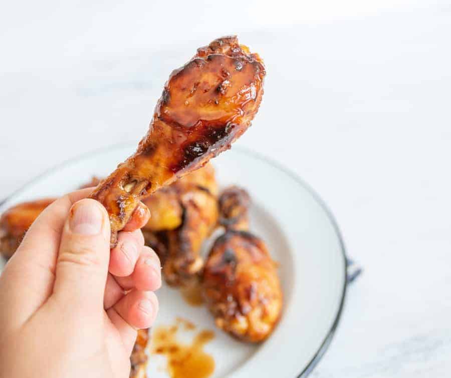 POV hand holding a chicken drum