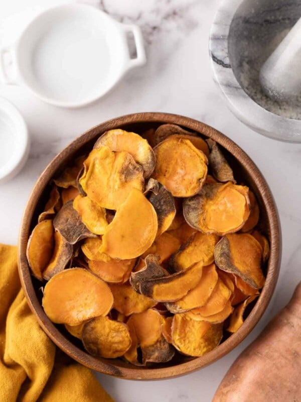 wooden bowl with air fried sweet potato chips.