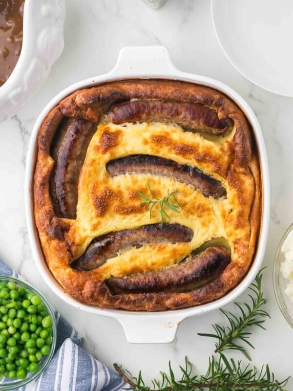 top view of a toad in a hole in a casserole dish baked and crispy dough